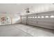 Spacious two car garage featuring white doors, a utility door, and an automatic opener, offering secure parking at 4195 Balmoral Castle Ct, Las Vegas, NV 89141