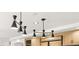 Modern kitchen lighting fixtures accent custom cabinets and built-in refrigerator at 4195 Balmoral Castle Ct, Las Vegas, NV 89141