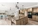 Modern kitchen with a large island, stainless steel appliances, and an open layout at 4195 Balmoral Castle Ct, Las Vegas, NV 89141