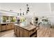 Open kitchen with island, granite countertops, and views of the pool and backyard at 4195 Balmoral Castle Ct, Las Vegas, NV 89141