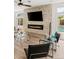 Living area featuring a modern stone fireplace, ceiling fan, and pool access at 4195 Balmoral Castle Ct, Las Vegas, NV 89141