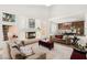 Open-concept living room showcasing a stone accent wall and direct access to a dining area at 4195 Balmoral Castle Ct, Las Vegas, NV 89141