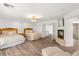 Large main bedroom featuring hardwood floors, two beds, fireplace, and an ensuite bathroom at 4195 Balmoral Castle Ct, Las Vegas, NV 89141