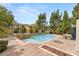 Inviting pool and spa surrounded by lush landscaping and a spacious patio for outdoor entertaining at 4195 Balmoral Castle Ct, Las Vegas, NV 89141