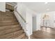 Beautiful staircase with wood treads, glass panel, and light wood railing leading to a main entry at 4195 Balmoral Castle Ct, Las Vegas, NV 89141
