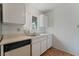Bright kitchen featuring white cabinets and a window over the sink at 420 Altamira Rd, Las Vegas, NV 89145