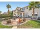 Expansive backyard with mature trees, patio, and a lush green lawn at 442 Beardsley Cir, Henderson, NV 89052