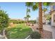 Lush backyard with a well-maintained lawn, landscaping, and patio area at 442 Beardsley Cir, Henderson, NV 89052