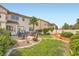 Picturesque backyard featuring a patio, green lawn, and beautiful landscaping at 442 Beardsley Cir, Henderson, NV 89052