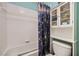 Bathroom featuring a white tiled bath and shower with stylish blue accents at 442 Beardsley Cir, Henderson, NV 89052