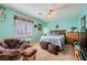 Bedroom featuring stylish decor, a cozy chair, and a view from the shuttered window at 442 Beardsley Cir, Henderson, NV 89052