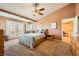 Bedroom featuring a tray ceiling, ceiling fan, and a comfortable bed with plenty of natural light at 442 Beardsley Cir, Henderson, NV 89052