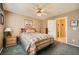 Cozy bedroom featuring a ceiling fan, carpeted floor, and a comfortable bed with patterned bedding at 442 Beardsley Cir, Henderson, NV 89052