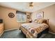 Cozy bedroom featuring a ceiling fan, carpeted floor, and a comfortable bed with patterned bedding at 442 Beardsley Cir, Henderson, NV 89052
