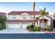 Inviting two-story home with a three-car garage, desert landscaping, and a red tile roof at 442 Beardsley Cir, Henderson, NV 89052