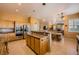 Spacious kitchen with stainless steel appliances, wood cabinets and an island perfect for gathering and entertaining at 442 Beardsley Cir, Henderson, NV 89052