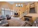 Open-concept living room featuring high ceilings, large windows, and cozy seating arrangement at 442 Beardsley Cir, Henderson, NV 89052