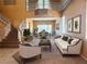 Bright living room featuring neutral tones, a staircase, and dining area at 442 Beardsley Cir, Henderson, NV 89052