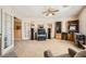 Spacious living room with carpeted floors, ceiling fan, and entertainment center at 442 Beardsley Cir, Henderson, NV 89052