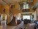 Spacious living room boasts soaring ceilings, staircase, and comfortable seating area at 442 Beardsley Cir, Henderson, NV 89052