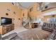Inviting living room with two-story ceilings, staircase, and comfortable leather seating at 442 Beardsley Cir, Henderson, NV 89052