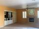 Bright living room featuring a fireplace, built-ins, and large windows at 442 Beardsley Cir, Henderson, NV 89052
