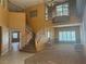 Open living area featuring a grand staircase and large windows at 442 Beardsley Cir, Henderson, NV 89052
