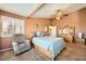 Inviting bedroom with a comfortable chair, warm lighting, and a plush bed at 442 Beardsley Cir, Henderson, NV 89052