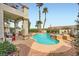 Sparkling backyard pool and jacuzzi surrounded by desert landscaping and lush palm trees at 442 Beardsley Cir, Henderson, NV 89052