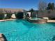 Backyard pool and jacuzzi features desert landscaping and mature privacy bushes at 442 Beardsley Cir, Henderson, NV 89052