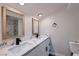 Modern bathroom with double sink vanity, sleek black fixtures, and framed mirrors above with a marble-look shower at 5129 Del Monte Ave, Las Vegas, NV 89146
