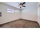 Cozy bedroom with soft carpet, ceiling fan, and a bright window offering pleasant natural light at 5129 Del Monte Ave, Las Vegas, NV 89146