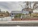 Charming home with a fenced yard, mature tree, and classic architectural details under a cloudy sky at 5129 Del Monte Ave, Las Vegas, NV 89146