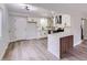 Modern kitchen featuring white cabinets, stainless steel appliances, and stylish island, complemented by sleek hardwood floors at 5129 Del Monte Ave, Las Vegas, NV 89146