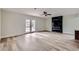 Spacious living room with modern fireplace, hardwood floors, and French doors leading to outdoor space at 5129 Del Monte Ave, Las Vegas, NV 89146