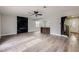 Bright living room with a sleek marble fireplace, hardwood floors, and seamless flow to the modern kitchen at 5129 Del Monte Ave, Las Vegas, NV 89146