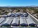Aerial view of a residential neighborhood highlighting the community layout and proximity to the city skyline and surrounding mountains at 5518 Stormy Night Ct, Las Vegas, NV 89120