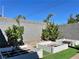 Inviting backyard featuring raised garden beds, artificial turf, and mature trees, perfect for gardening and outdoor enjoyment at 5518 Stormy Night Ct, Las Vegas, NV 89120