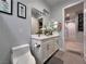 Bright bathroom with white vanity, double sinks, and a large mirror at 5518 Stormy Night Ct, Las Vegas, NV 89120