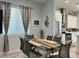 Dining area adjacent to kitchen, featuring stainless steel appliances and white cabinetry at 5518 Stormy Night Ct, Las Vegas, NV 89120