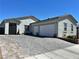 Charming single-story home featuring a three-car garage and a beautifully paved driveway at 5518 Stormy Night Ct, Las Vegas, NV 89120
