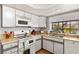 Well-lit kitchen featuring ample counter space, modern appliances, and a window overlooking the yard at 5709 Colwood Ln, Las Vegas, NV 89130