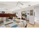 Bright main bedroom features a ceiling fan, mirrored wall, and walk-in closet with custom organizers at 5709 Colwood Ln, Las Vegas, NV 89130