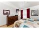 Comfortable bedroom with a large bed, hardwood floors, and a view to the outside at 5709 Colwood Ln, Las Vegas, NV 89130