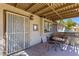 The cozy patio features a wrought iron table and chairs plus a grill at 5709 Colwood Ln, Las Vegas, NV 89130
