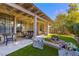 The outdoor patio features a ceiling fan, outdoor seating and a beautiful backyard at 5709 Colwood Ln, Las Vegas, NV 89130