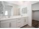 Modern bathroom with double sinks, white cabinets, and large mirror above at 600 N Carriage Hill Dr # 2174, Las Vegas, NV 89138