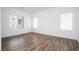 An airy room with lots of natural light from two windows and hardwood floors at 600 N Carriage Hill Dr # 2174, Las Vegas, NV 89138