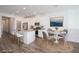 Bright kitchen featuring white cabinets, stainless steel appliances, an island with seating, and a dining table at 600 N Carriage Hill Dr # 2174, Las Vegas, NV 89138