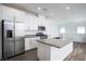 Modern kitchen with stainless steel appliances, gray countertops, a center island, and white cabinetry at 600 N Carriage Hill Dr # 2174, Las Vegas, NV 89138